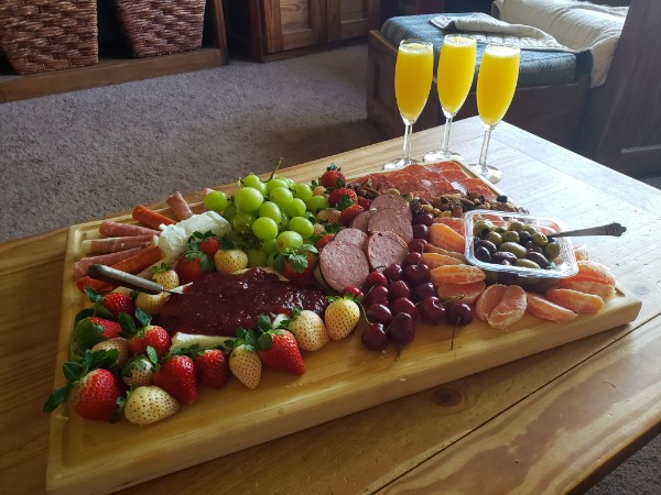 Grazing board with fruit, charcuterie and sparkling drinks